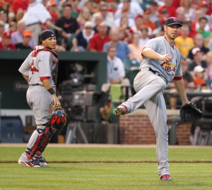 Yadier Molina watches on as Chris Carpenter lets fly with a throw to first and the gassy aftermath of the day's lunch.